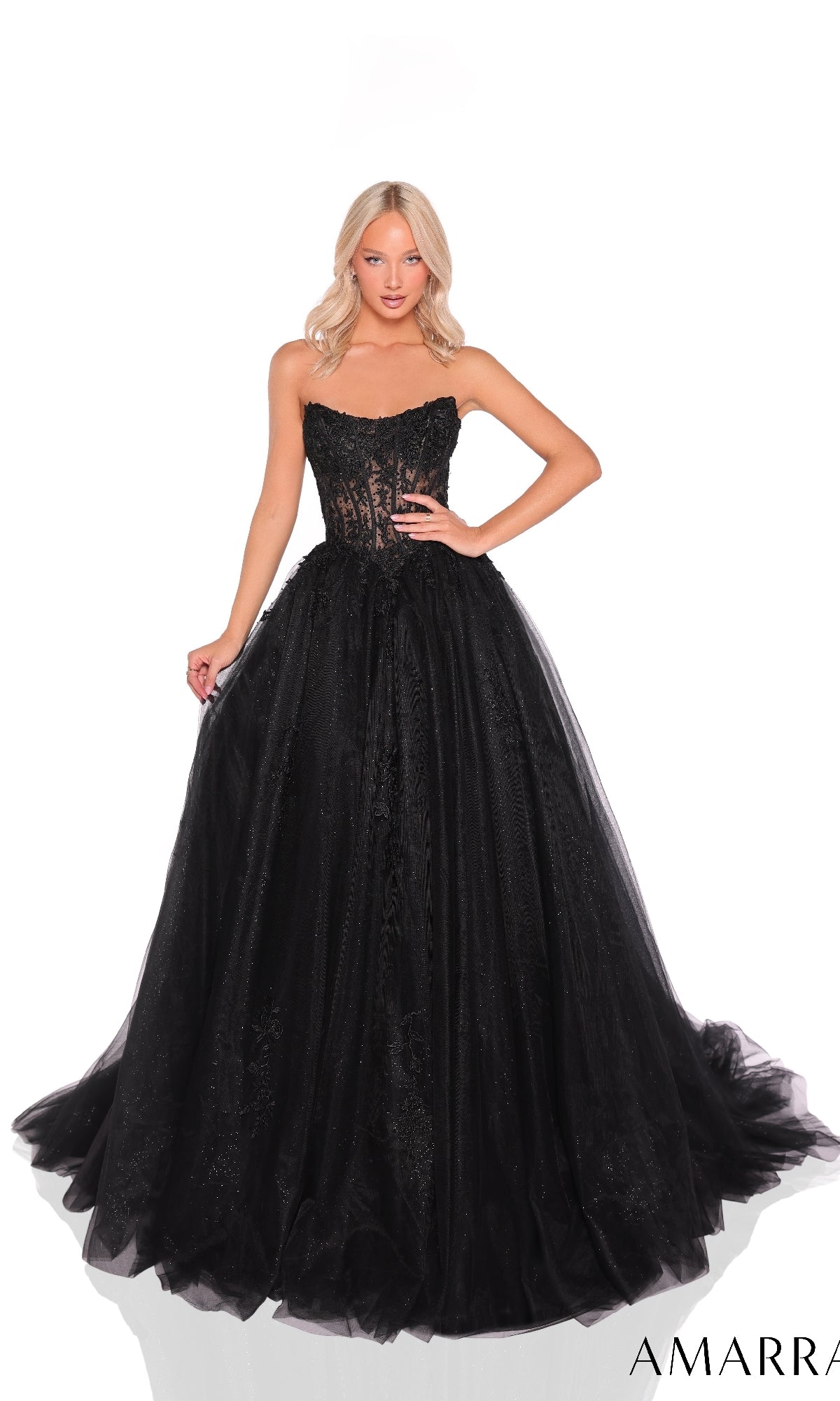 A woman poses in the Amarra 88913 Strapless Long Prom Ball Gown, featuring a sheer lace corset bodice and a full tulle skirt, set against a white background.